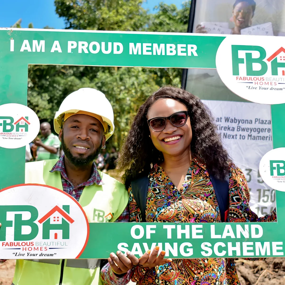 Company male surveyor with female client holding green banner.